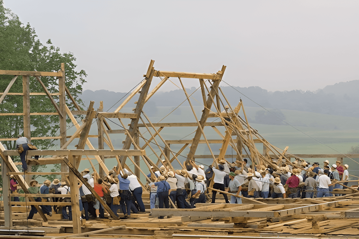 the amish community raising a timber frame barn